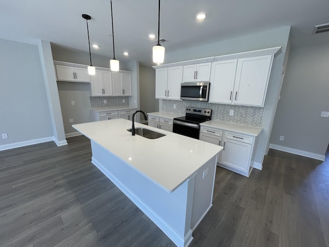 kitchen featuring electric range, white cabinetry, a kitchen island with sink, and sink