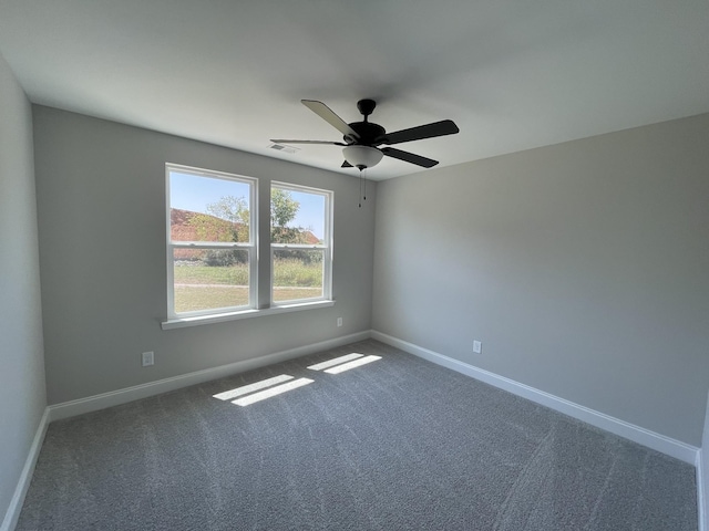 spare room with carpet floors and ceiling fan