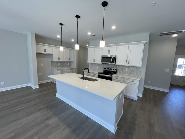 kitchen featuring electric range oven, white cabinetry, sink, and hanging light fixtures