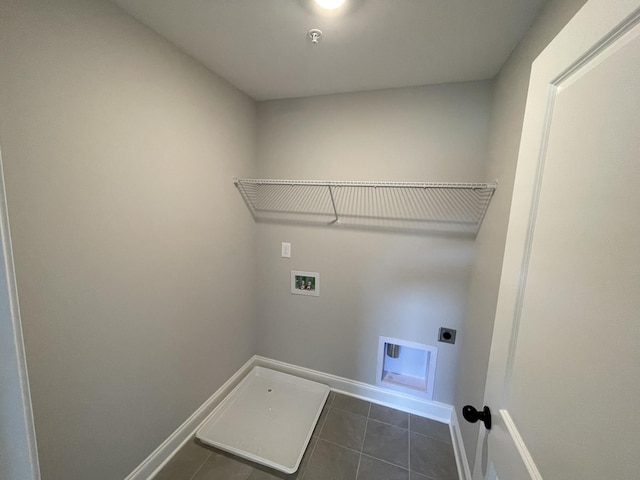 clothes washing area with dark tile patterned floors, washer hookup, and hookup for an electric dryer