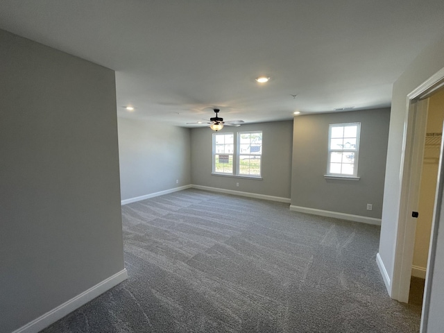 spare room with ceiling fan and carpet