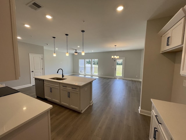 kitchen with dishwasher, a center island with sink, ceiling fan with notable chandelier, white cabinets, and sink