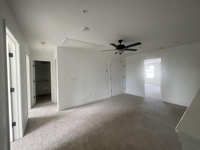 spare room featuring ceiling fan and light colored carpet