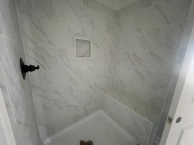 bathroom with a tile shower