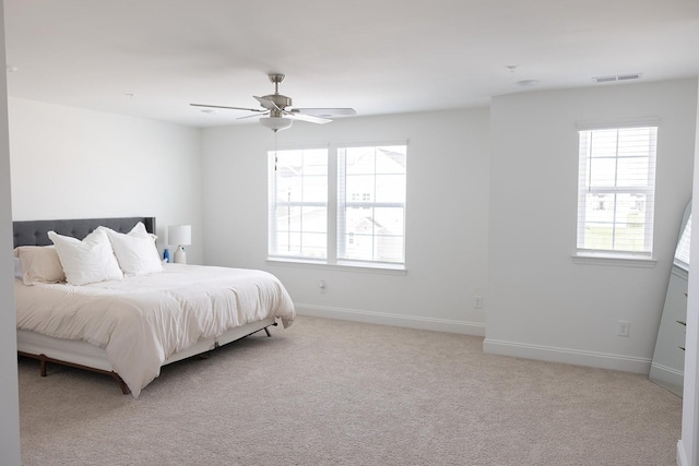 bedroom with light carpet and ceiling fan