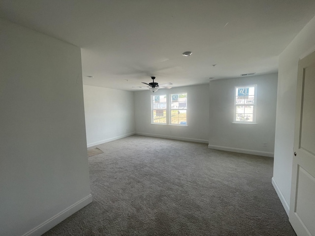 carpeted spare room with ceiling fan