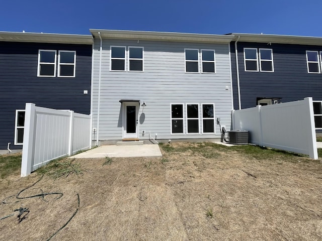 rear view of house featuring a patio area and cooling unit