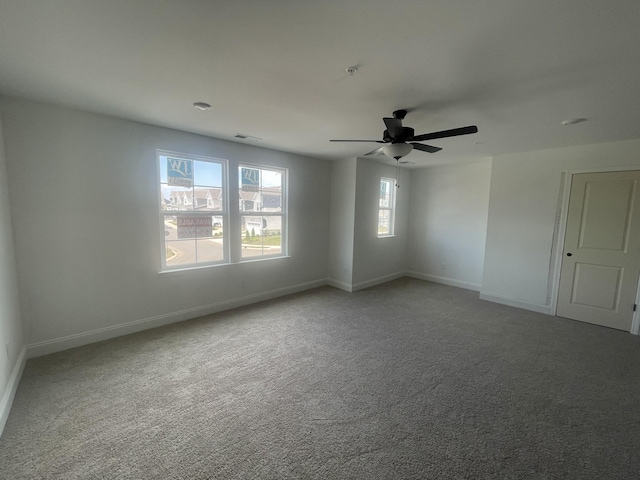 carpeted empty room featuring ceiling fan