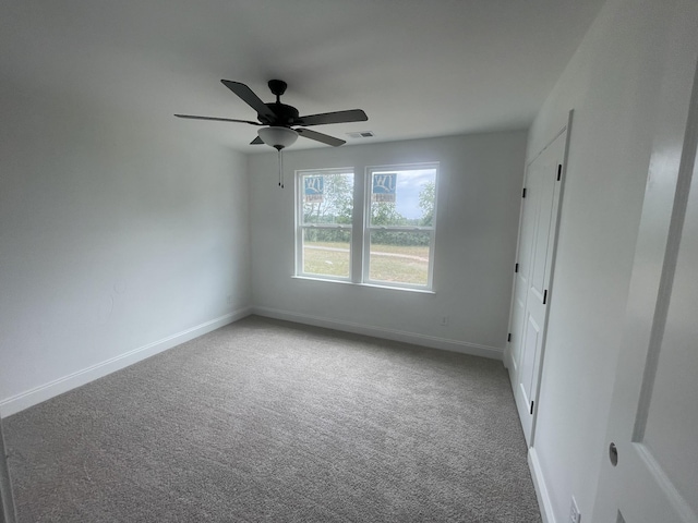 spare room with carpet flooring and ceiling fan