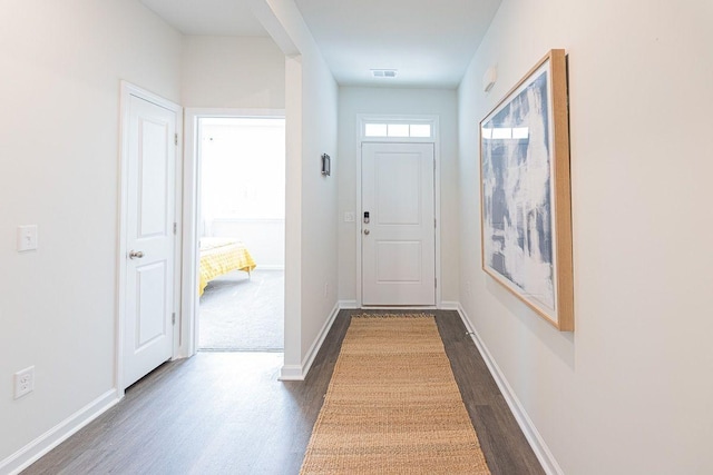 doorway with dark wood-type flooring