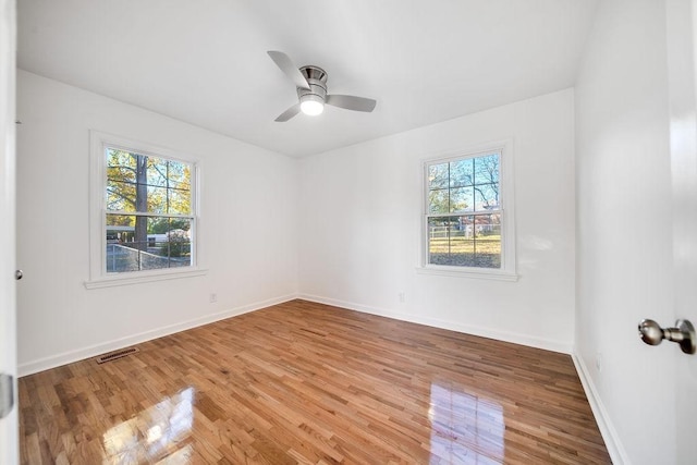 unfurnished room featuring ceiling fan and hardwood / wood-style flooring