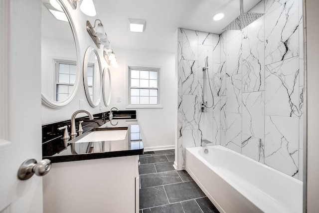 bathroom with vanity and tiled shower / bath