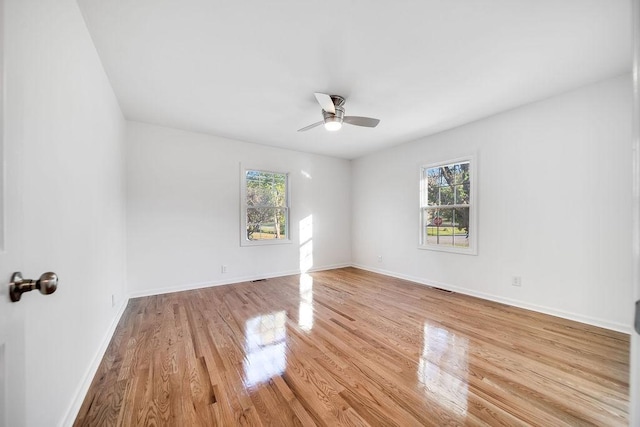 spare room with light wood-type flooring and ceiling fan