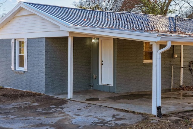 view of exterior entry with a carport