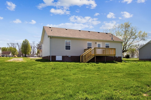 rear view of house featuring a yard and a wooden deck