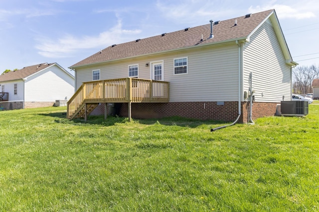 rear view of house featuring central AC, a lawn, and a wooden deck