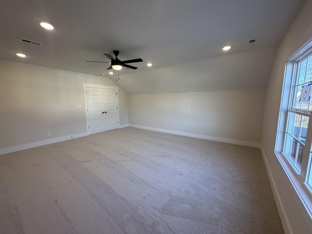 bonus room with light colored carpet, ceiling fan, and vaulted ceiling