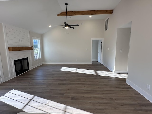 unfurnished living room with a fireplace, dark wood-type flooring, ceiling fan, and vaulted ceiling with beams