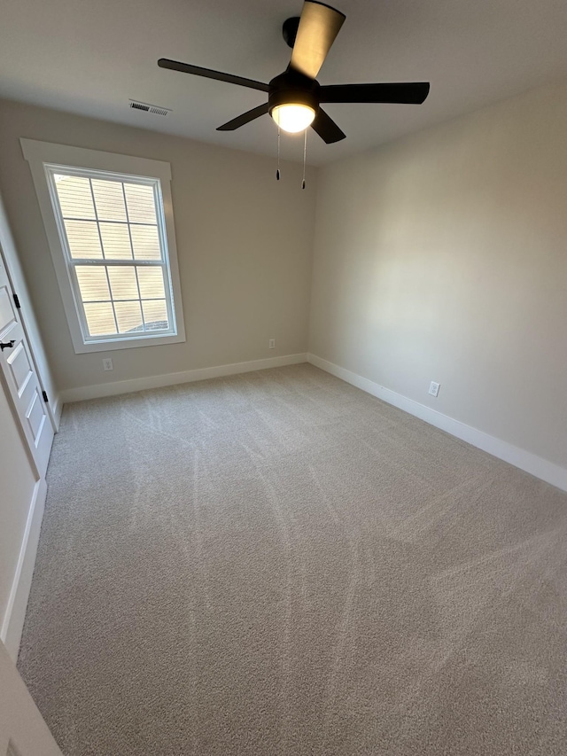 empty room with light colored carpet and ceiling fan