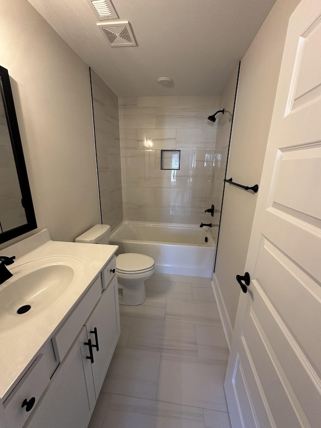 full bathroom featuring toilet, vanity, and tiled shower / bath combo