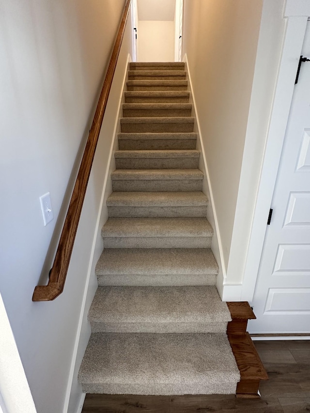 staircase featuring hardwood / wood-style floors