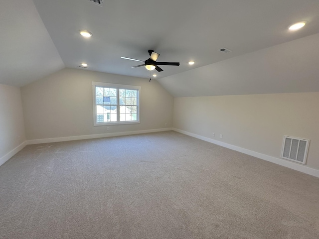 additional living space with ceiling fan, vaulted ceiling, and carpet flooring