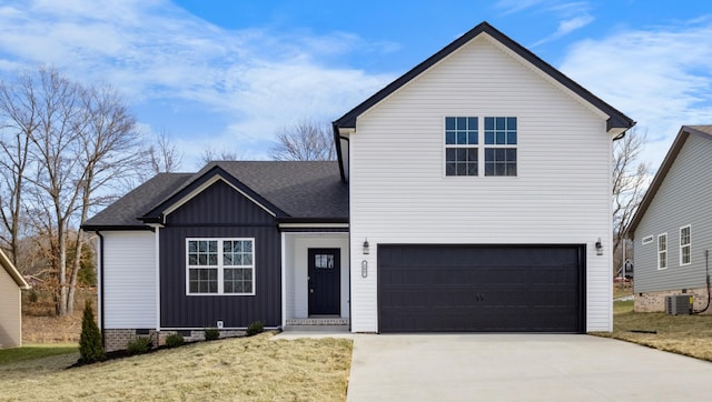 view of front of property featuring a garage, a front lawn, and central air condition unit