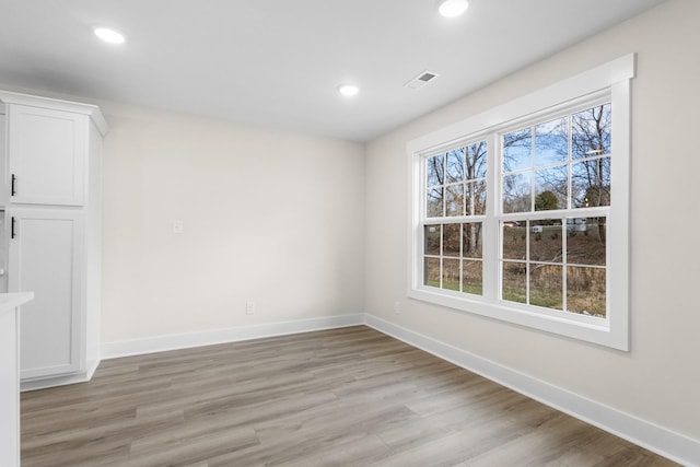 unfurnished dining area with light wood-type flooring