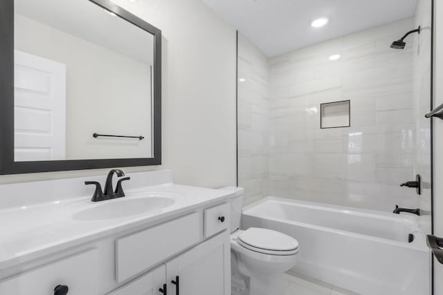 full bathroom with toilet, vanity, and tiled shower / bath