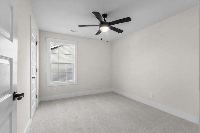 spare room with light carpet and ceiling fan