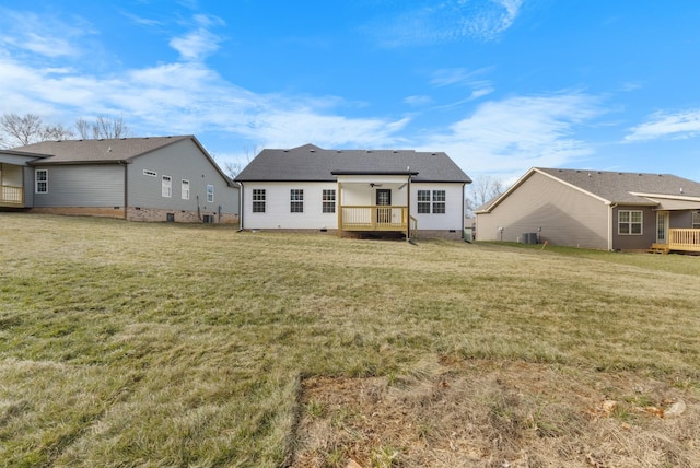 rear view of property with a wooden deck, a lawn, and central air condition unit