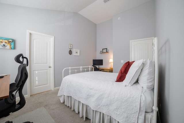 carpeted bedroom with lofted ceiling