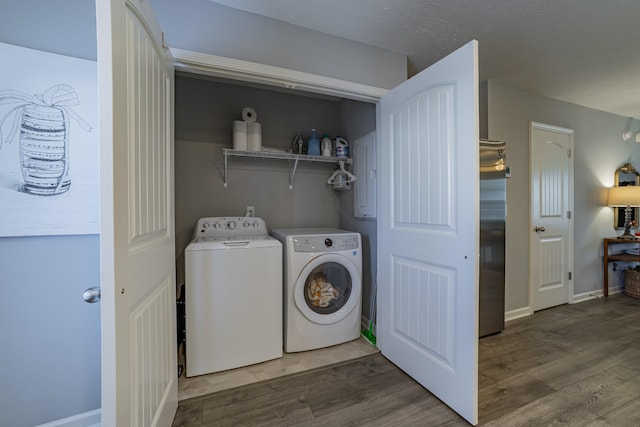 laundry area with dark wood-type flooring and washer and clothes dryer