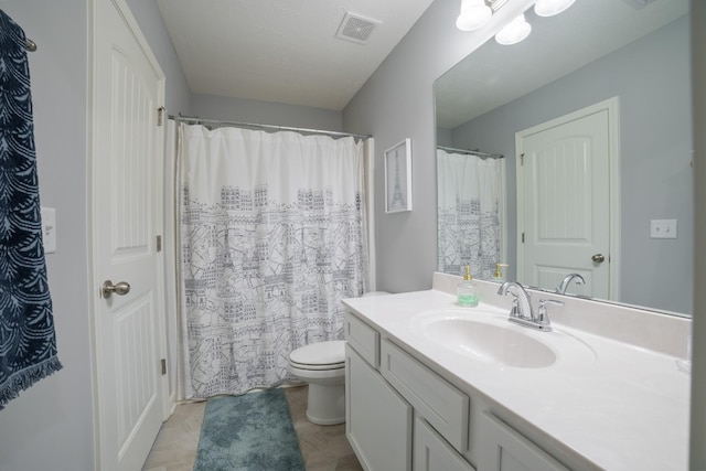 bathroom with toilet and vanity