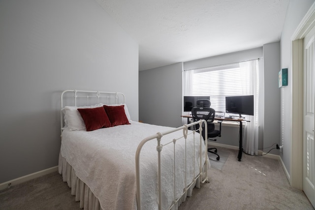 bedroom with light colored carpet and a textured ceiling