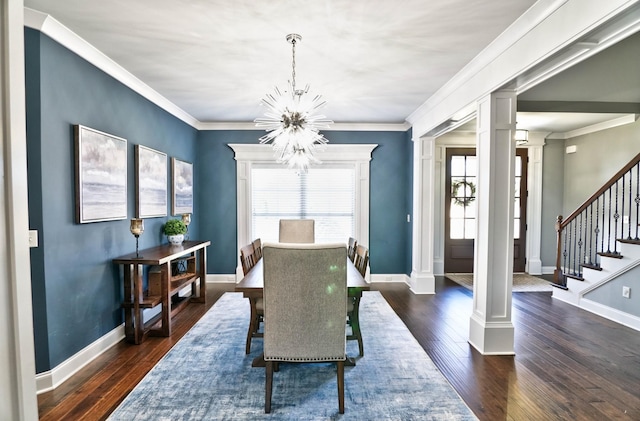 dining area featuring ornate columns, ornamental molding, a notable chandelier, and dark wood-type flooring