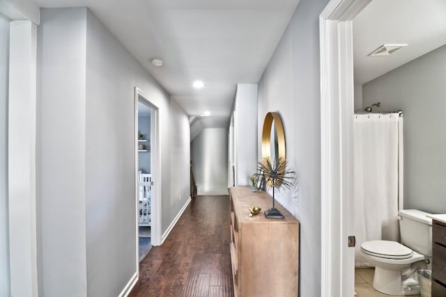 corridor featuring dark wood-type flooring