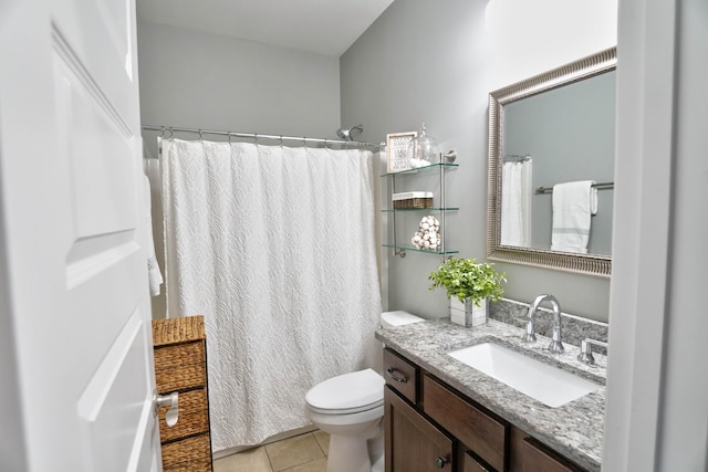 bathroom featuring toilet, tile patterned flooring, and vanity