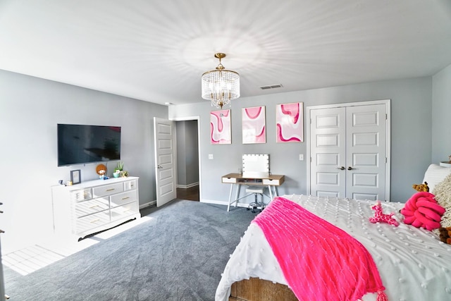 bedroom with dark colored carpet, a notable chandelier, and a closet