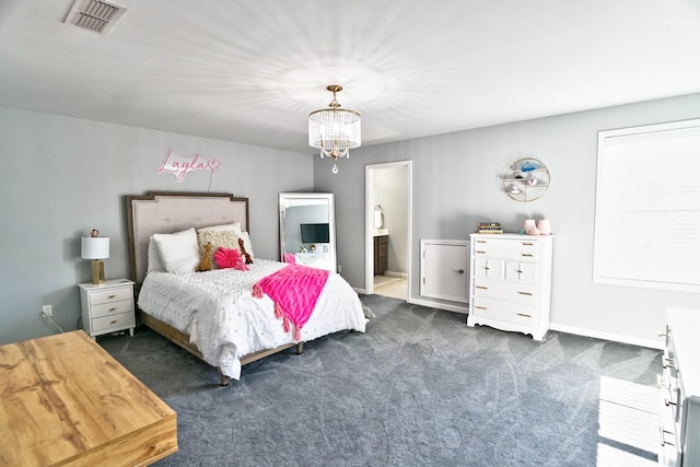 bedroom with dark carpet, a chandelier, and connected bathroom