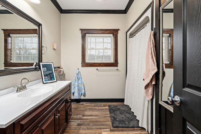 bathroom with wood-type flooring, vanity, and ornamental molding