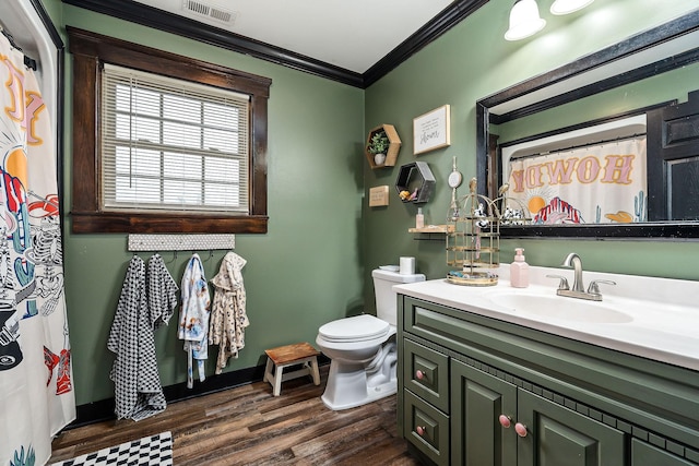 bathroom with toilet, wood-type flooring, vanity, and crown molding