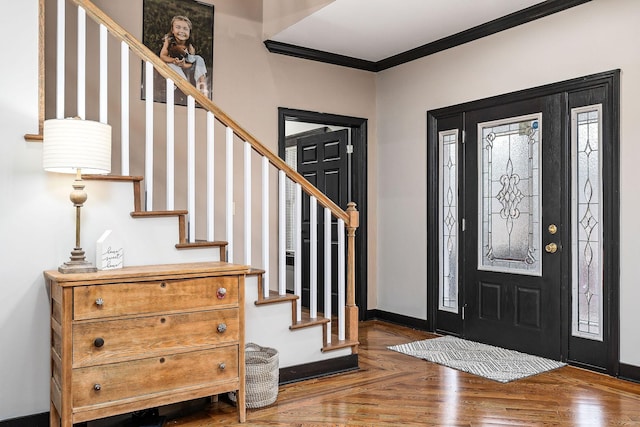 foyer with dark parquet flooring and crown molding