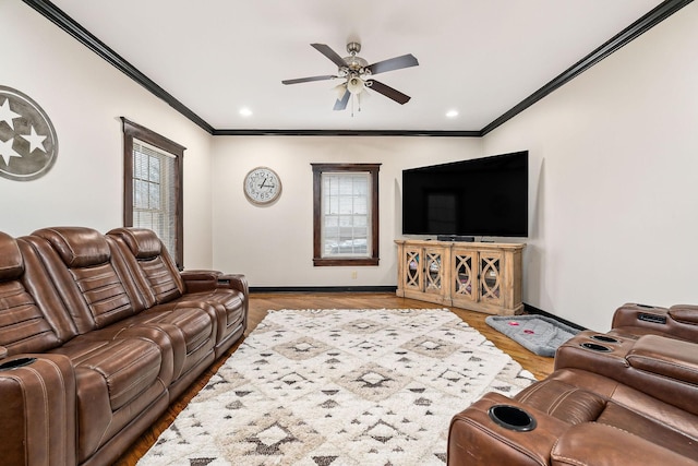 living room with hardwood / wood-style flooring, ceiling fan, and ornamental molding