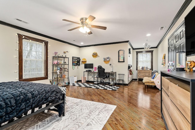 bedroom featuring ornamental molding, ceiling fan, and dark hardwood / wood-style floors