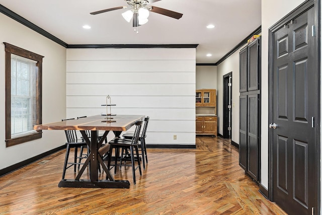 dining space with ornamental molding and ceiling fan