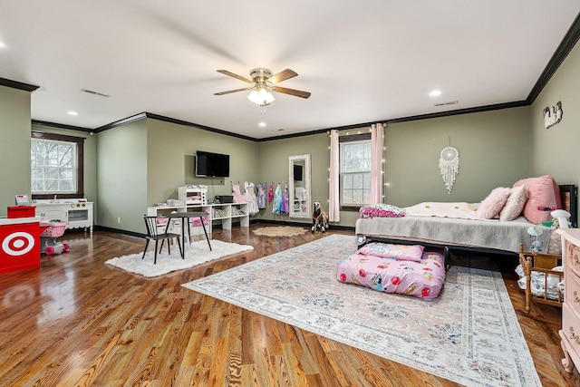 bedroom with hardwood / wood-style floors, ceiling fan, and ornamental molding