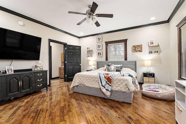 bedroom with ceiling fan, hardwood / wood-style flooring, and crown molding