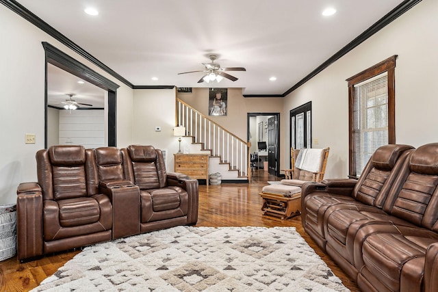 living room with ornamental molding, ceiling fan, and dark hardwood / wood-style flooring