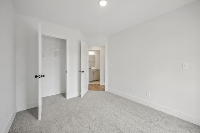 unfurnished bedroom featuring a closet and light carpet